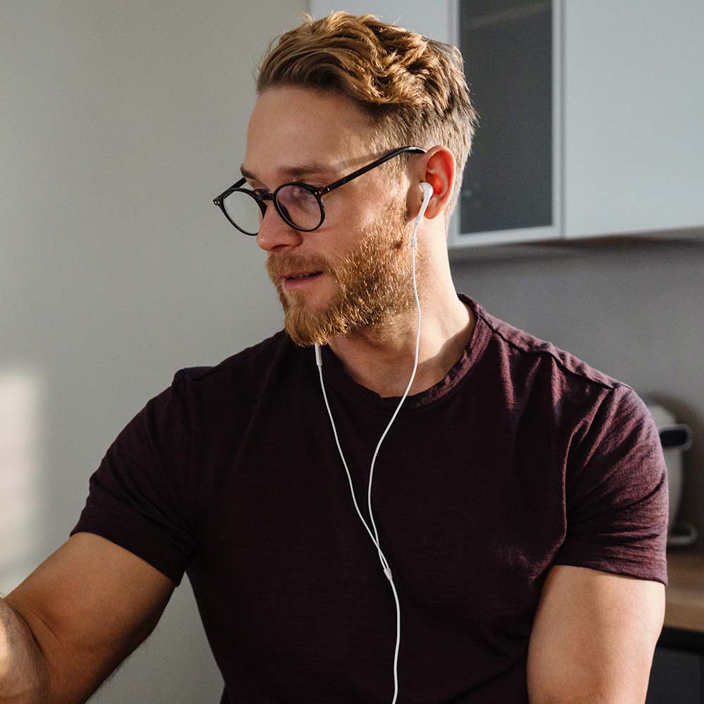 portrait of young man in earphones sitting with ce Y928VMA